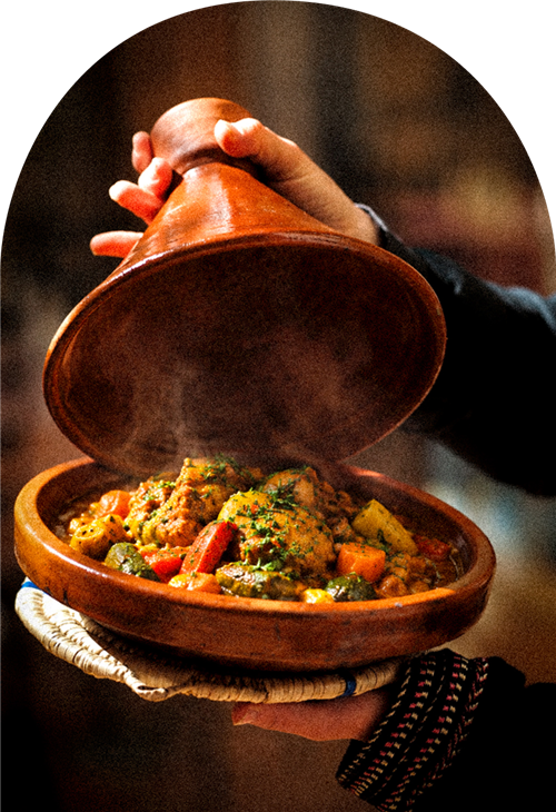 Tajine fumant ouvert par des mains expertes